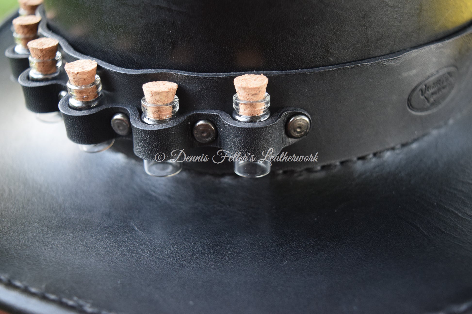 black leather alchemist / plague doctor hat - close up of the crown strap holding the glass vials with corks
