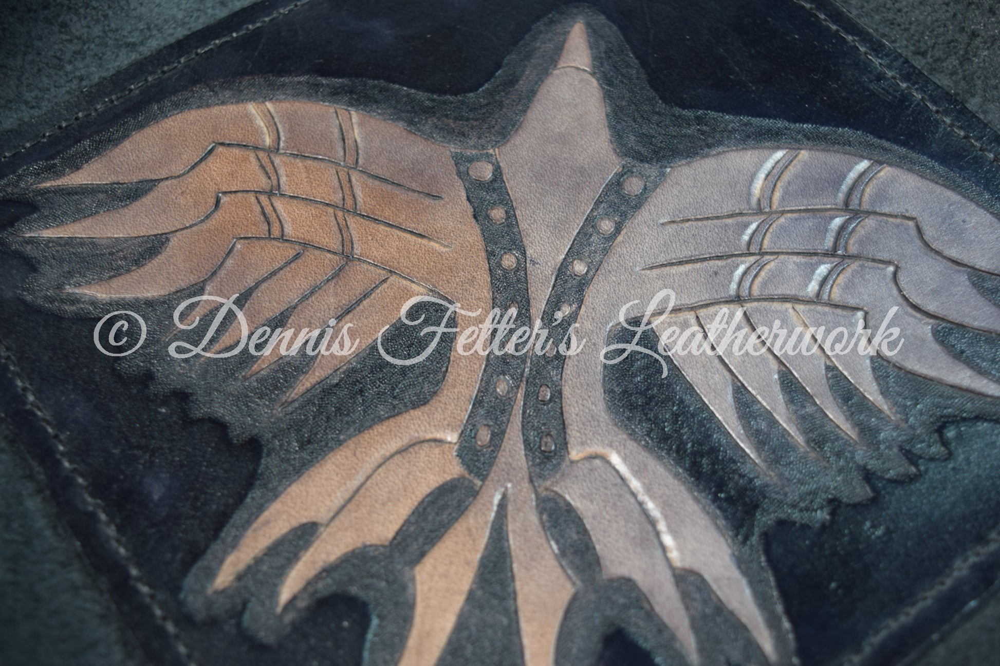 Black leather dice / valet tray - overhead view of the tooled bird