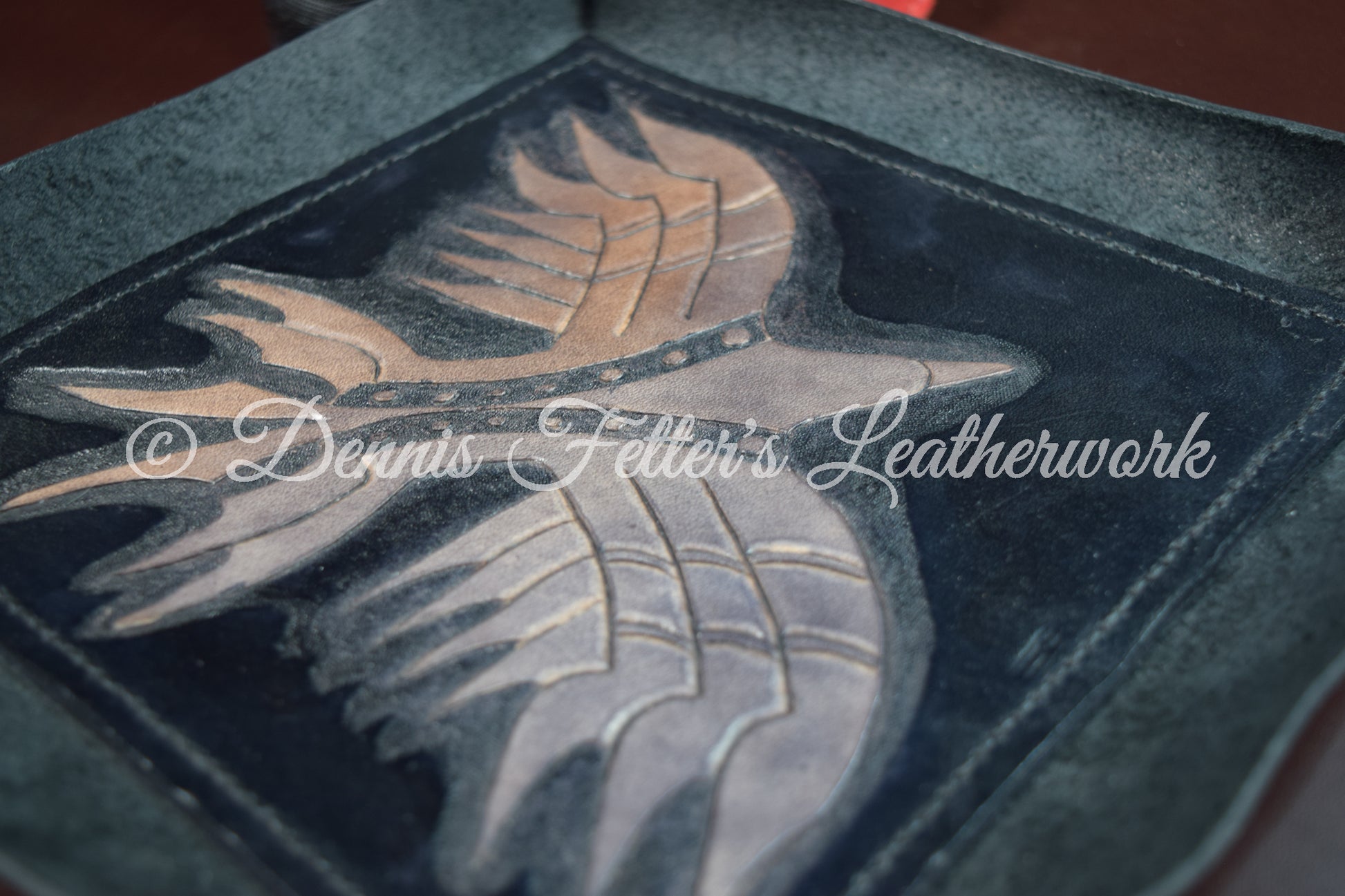 Black leather dice / valet tray - zoomed in view of the bird tooled into the leather